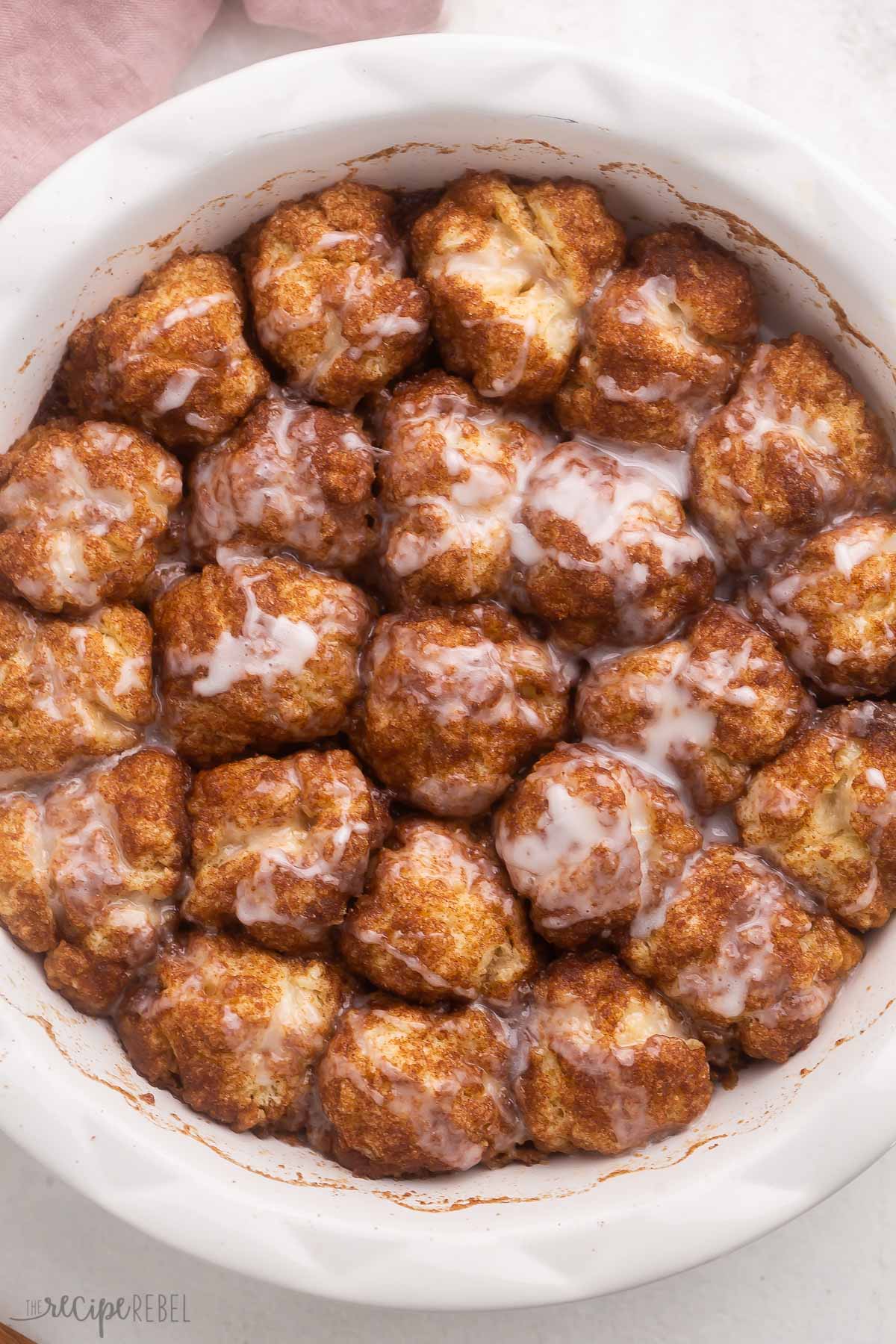 overhead view of a round white dish filled with cinnamon roll bites.