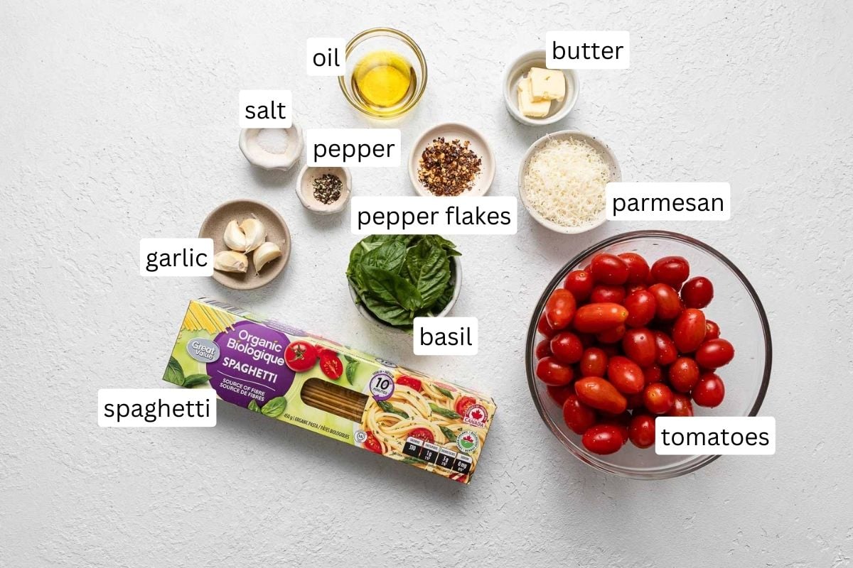 tomato basil pasta ingredients on a white surface.