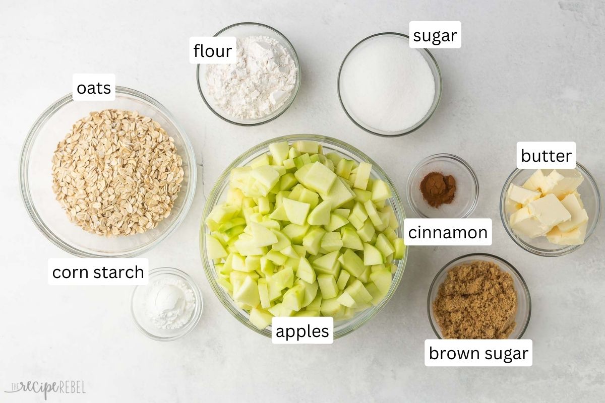 overhead of ingredients for apple crisp in a glass bowls.