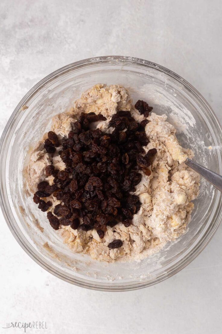 raisins added to scone mixture in glass bowl.