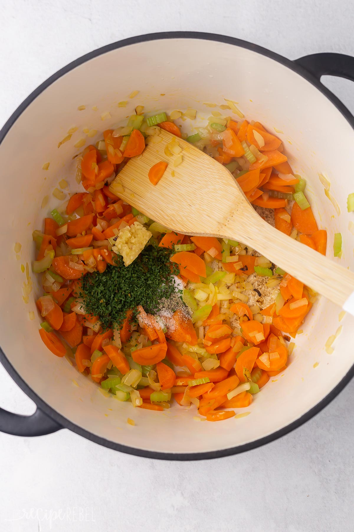 black pot with sauteed vegetables and spices added.