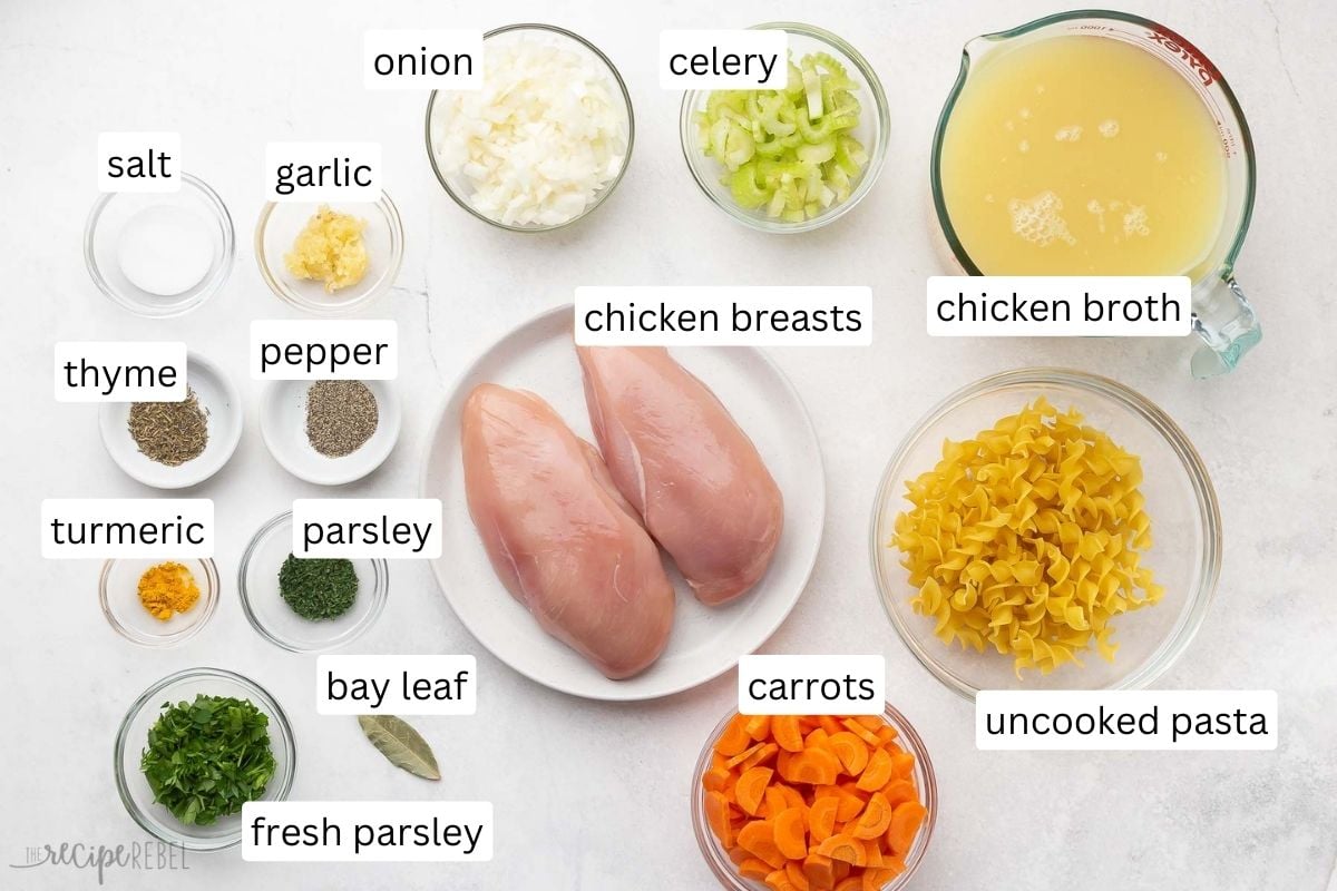 ingredients for crockpot chicken noodle soup in glass bowls.