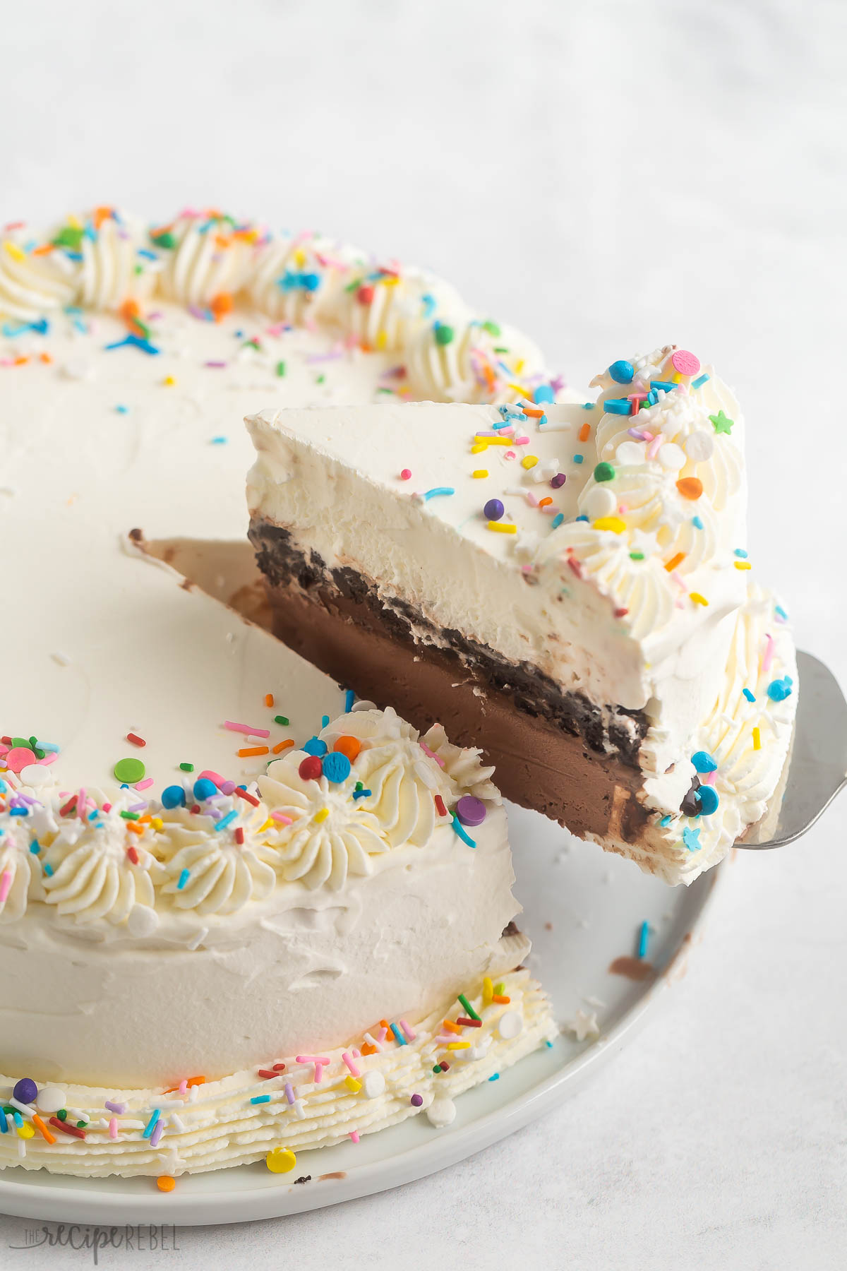 piece being lifted out of whole dq ice cream cake.
