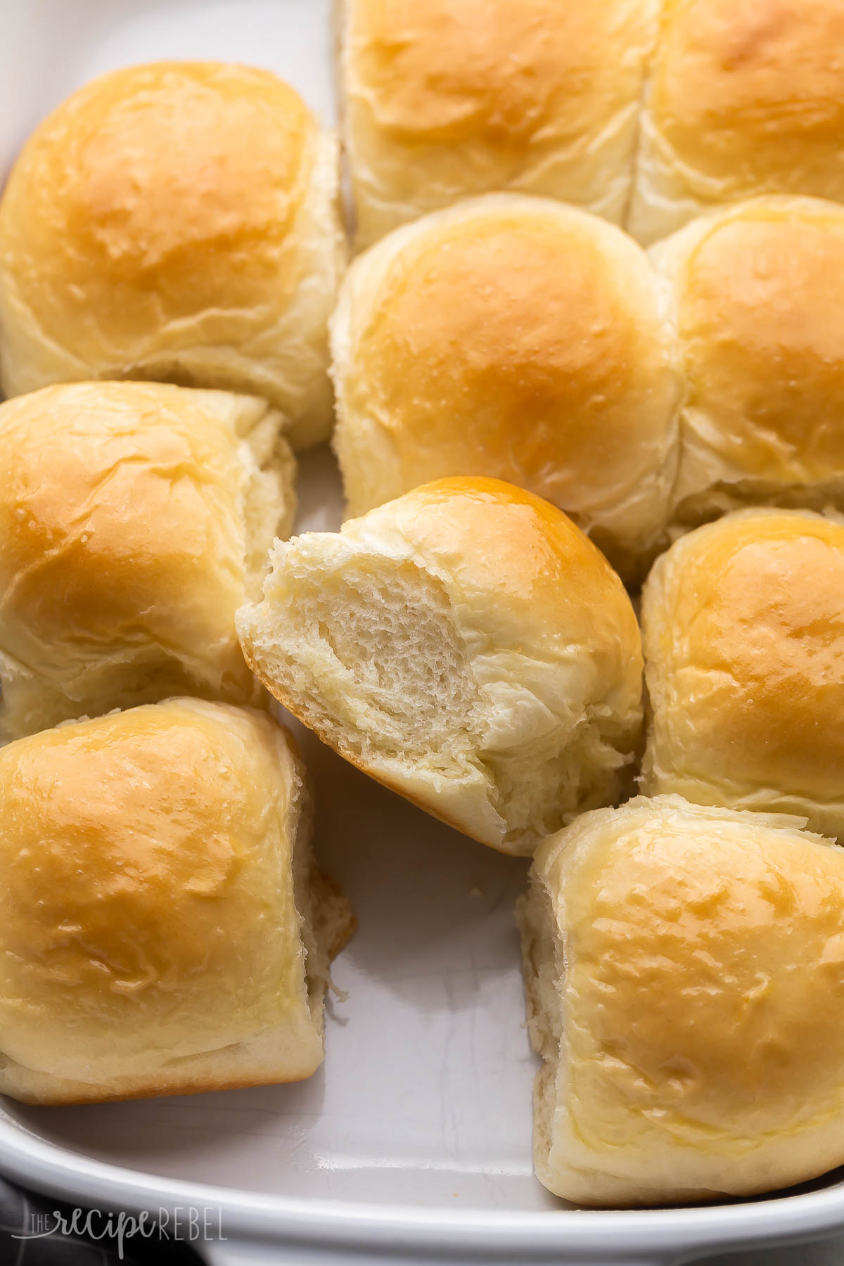 freshly baked dinner rolls in white baking dish.