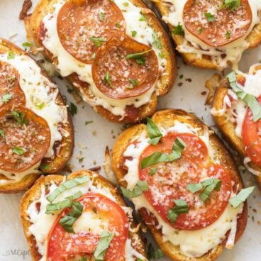 square image of pizza toast on baking sheet.