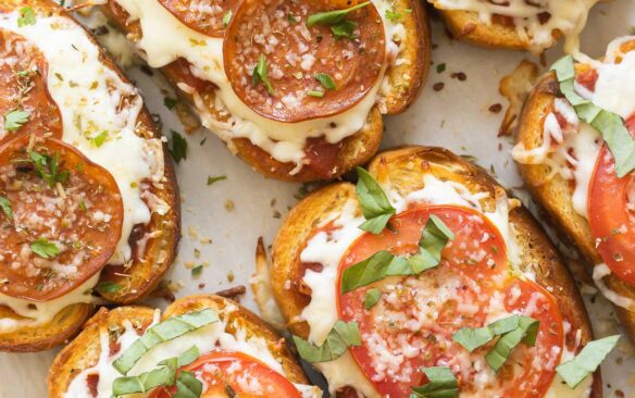 square image of pizza toast on baking sheet.