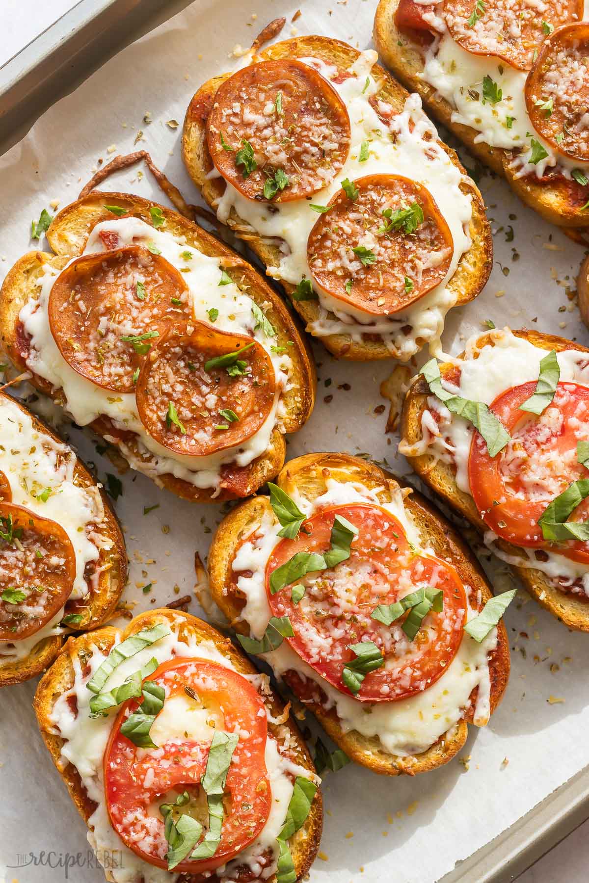 pepperoni and margherita pizza toast on baking sheet.