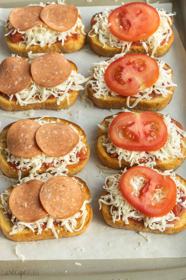 pepperoni slices and tomato slices on top of cheese to make pizza toast.