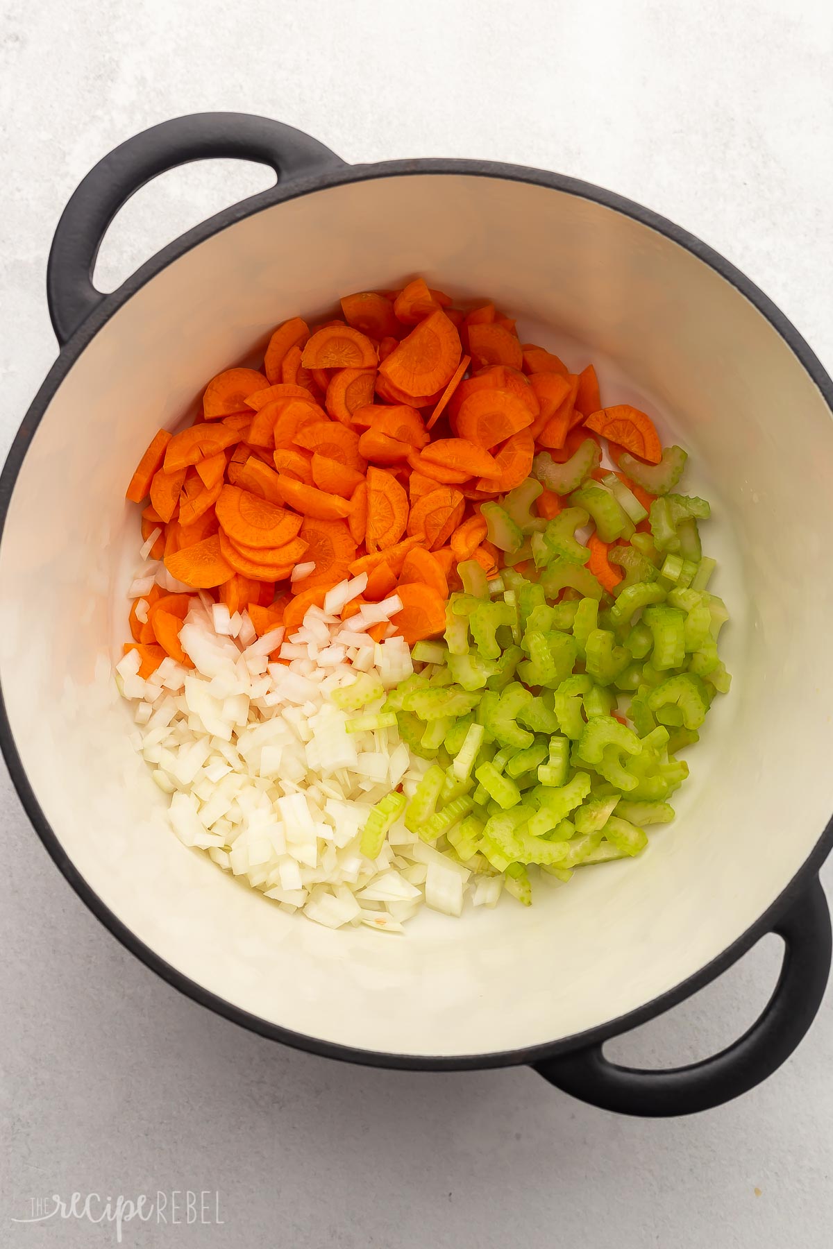 dutch oven filled with carrots, onions, and celery.