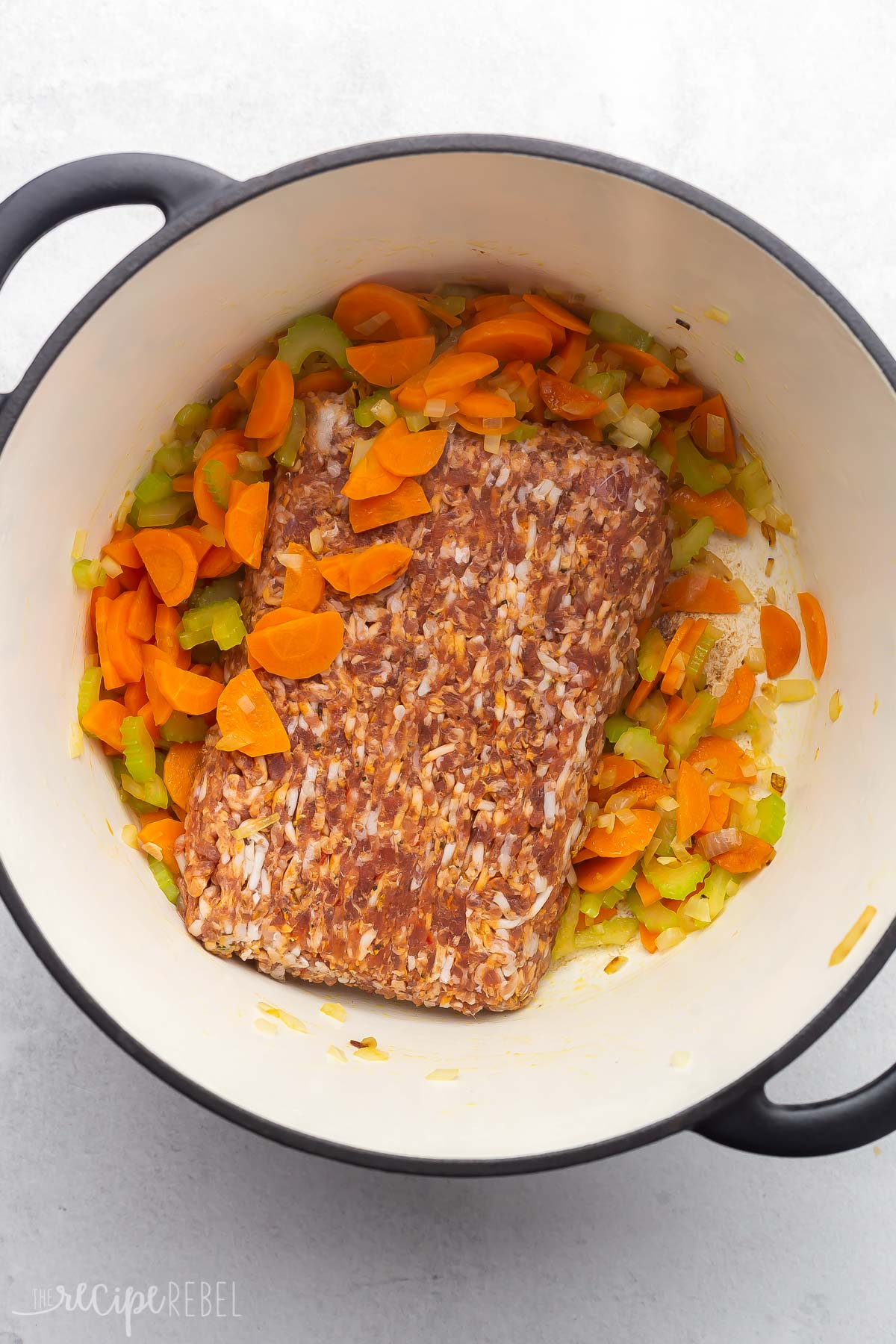 dutch oven filled with sauteed vegetables and Italian sausage.