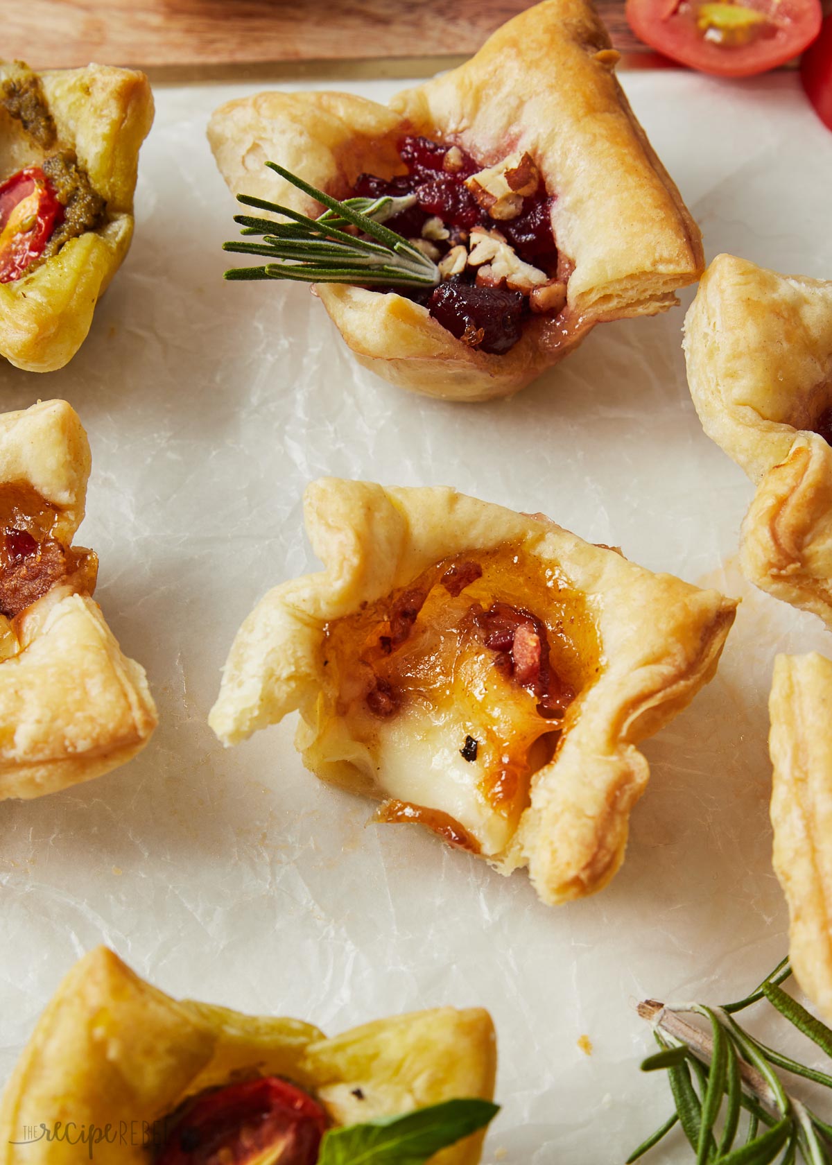 Top view close up of baked brie bites on a white worktop.