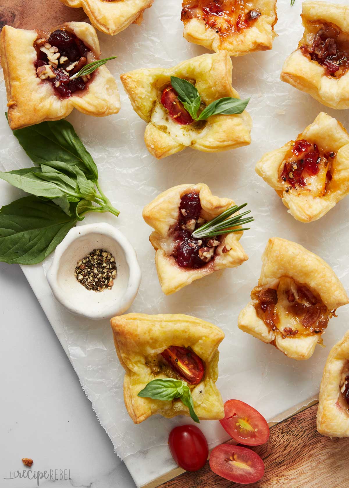 Top view of a baked brie bites on a white surface.