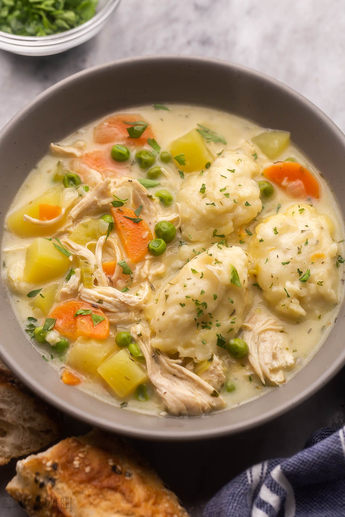 grey bowl filled with chicken dumpling soup.