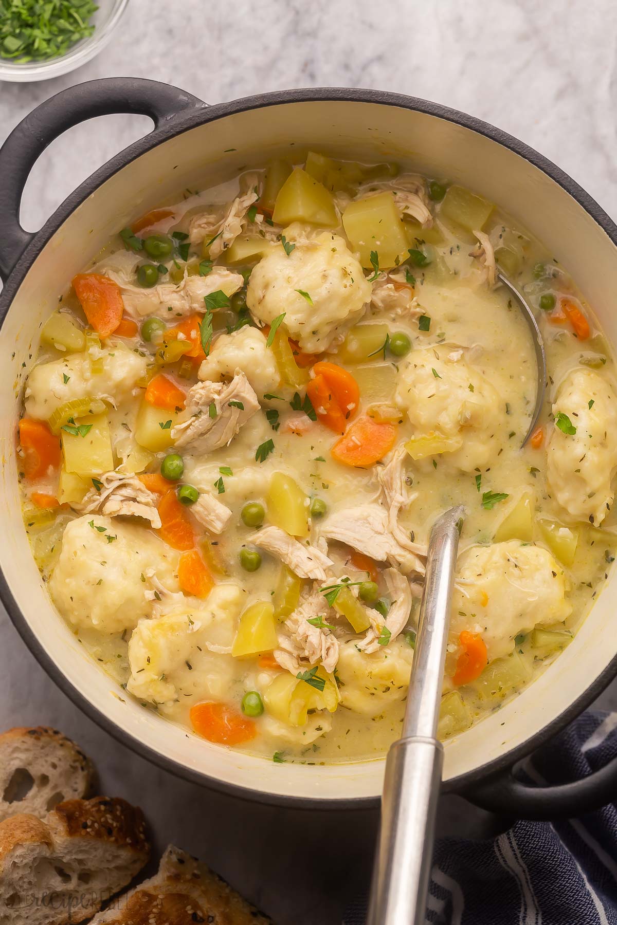 black pot filled with chicken dumpling soup.