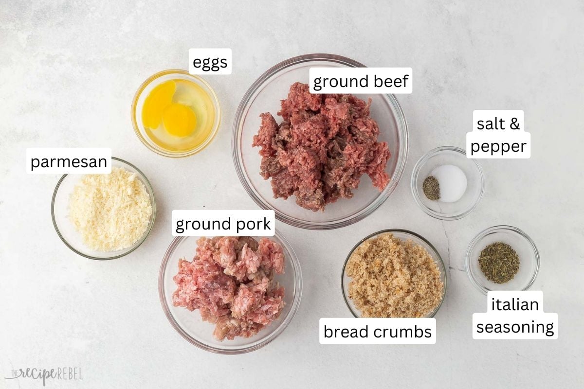 Top view of ingredients for Italian meatbals in glass bowls.