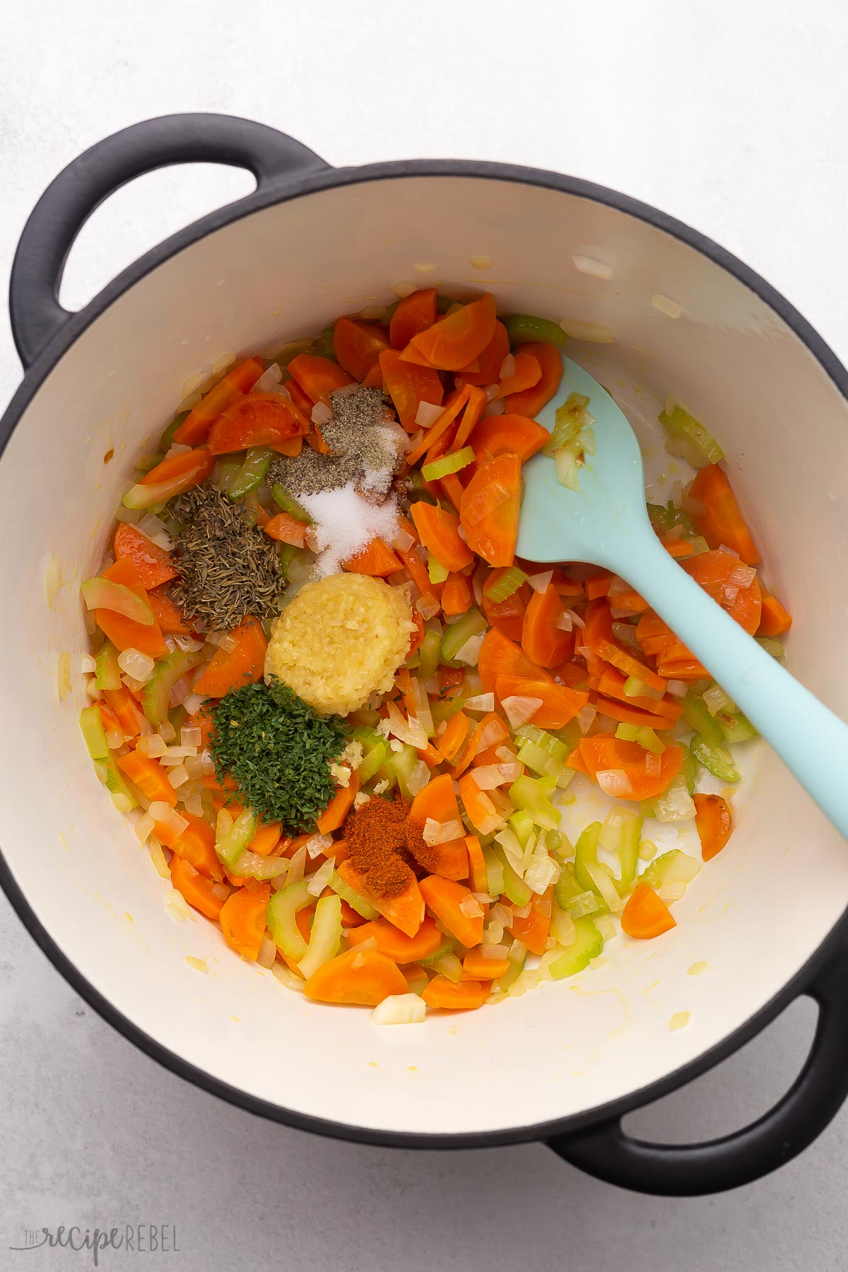 sauteed vegetables in pot with spices added.