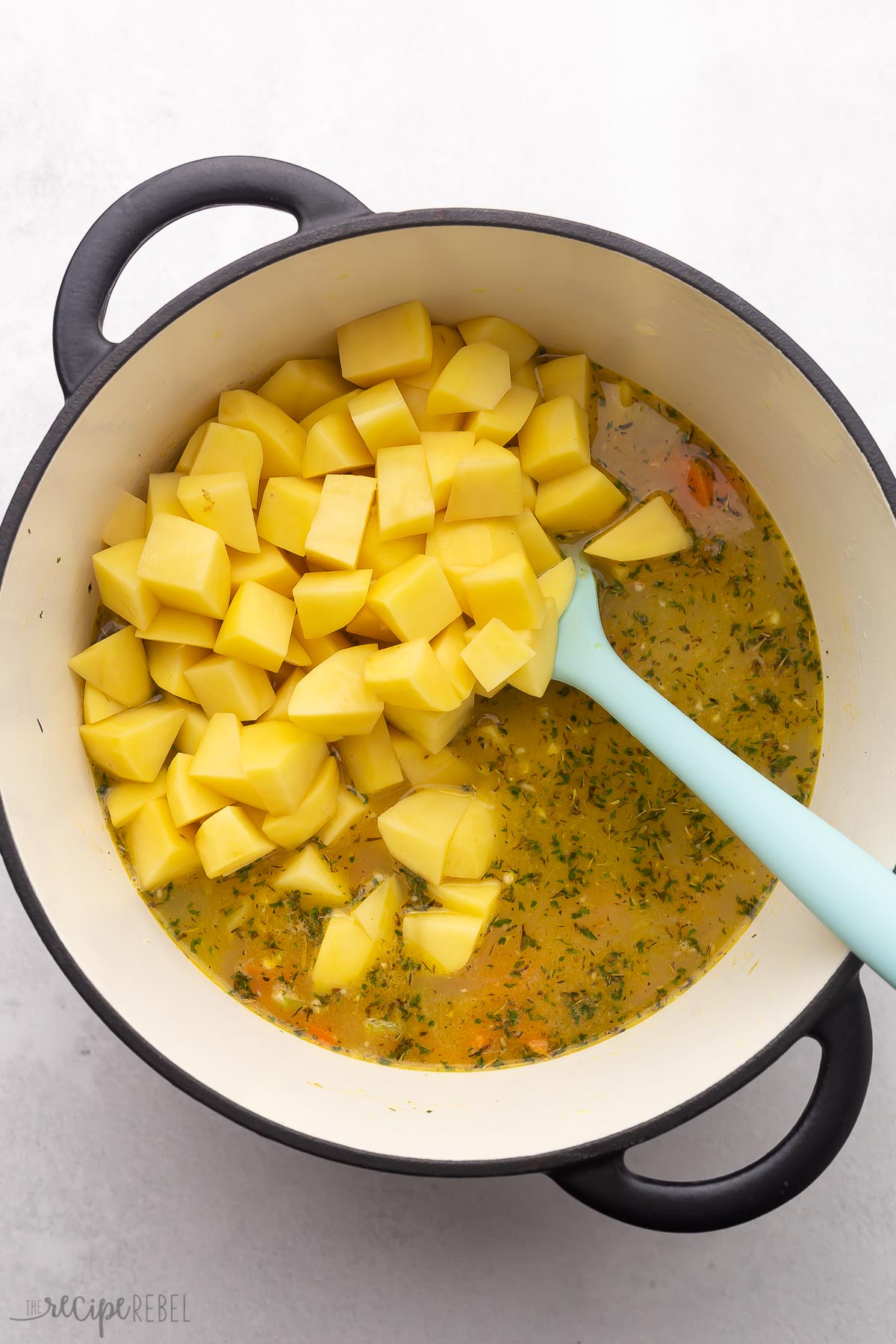 chopped potatoes added into pot with other ingredients.