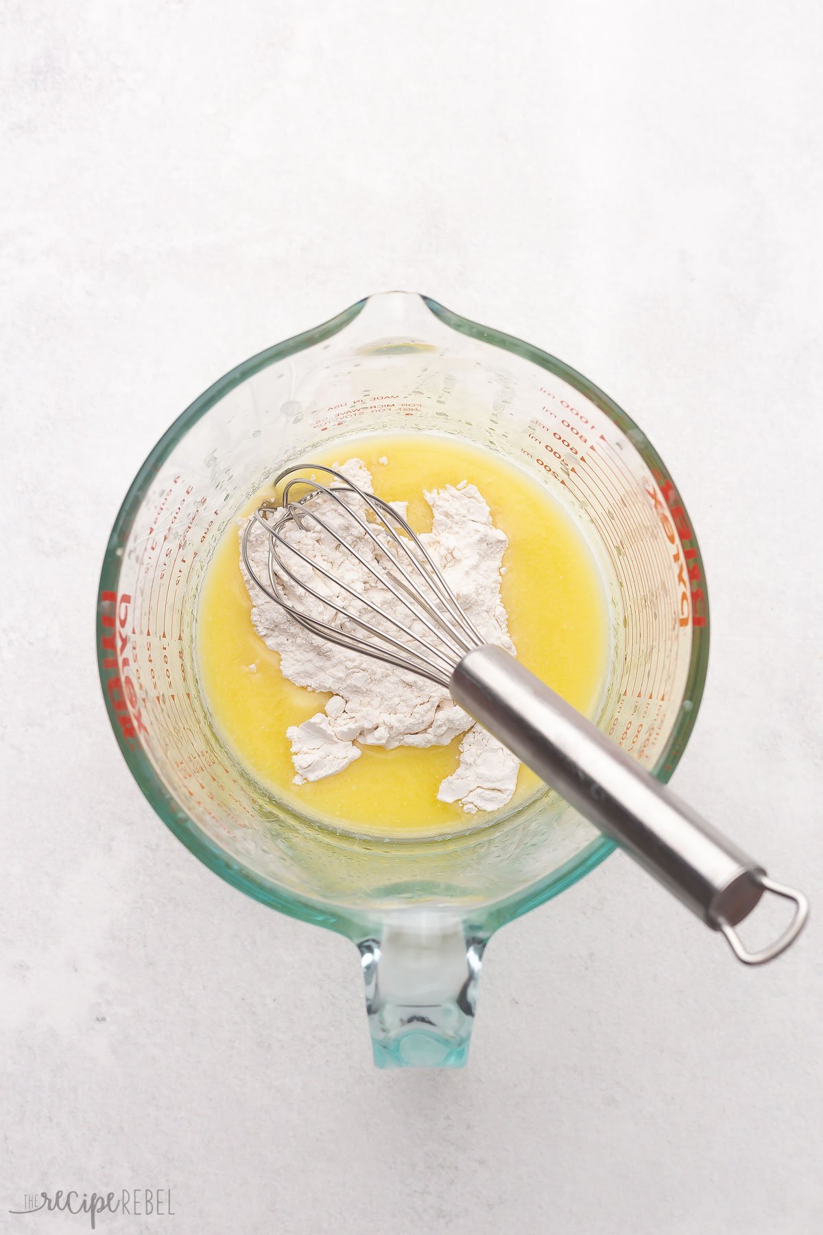 melted butter and flour in a glass measuring cup with whisk.