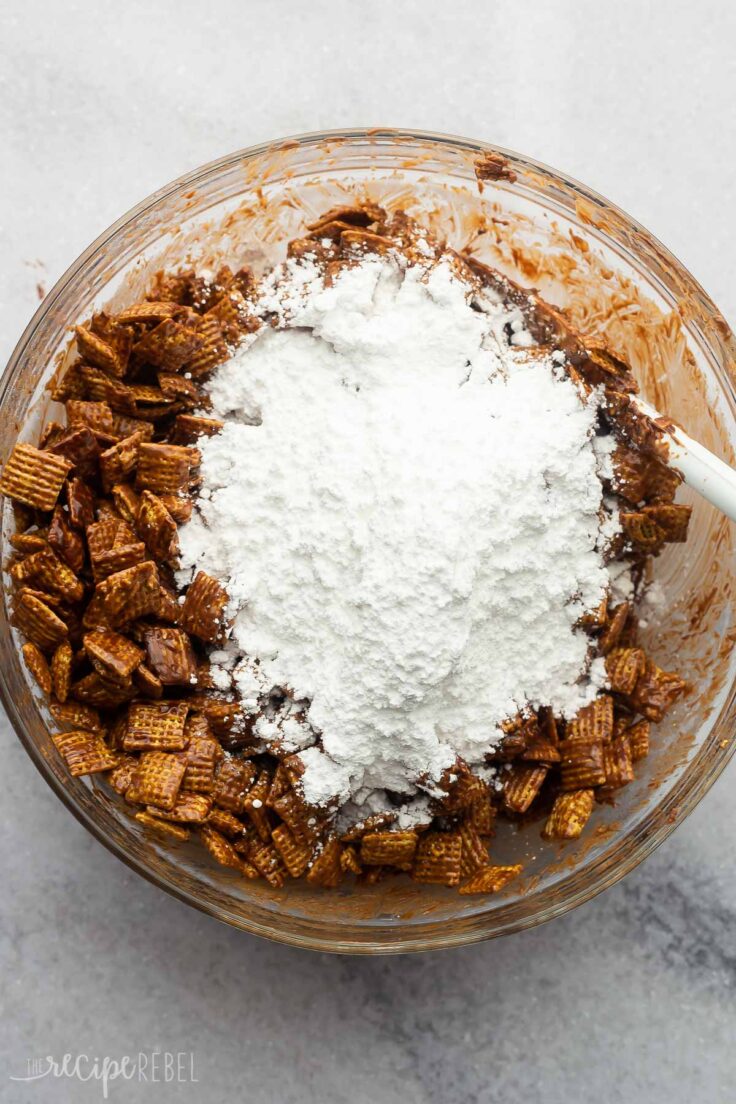 chocolate coated puppy chow with powdered sugar poured on top.