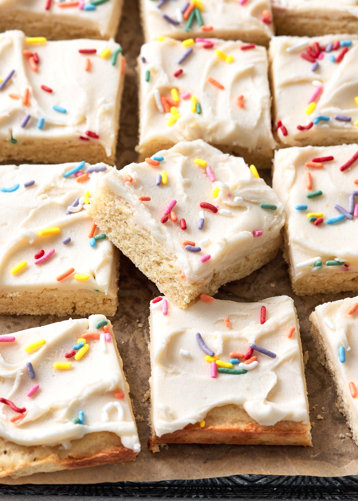 Close up of sugar cookie bar squares on a surface.