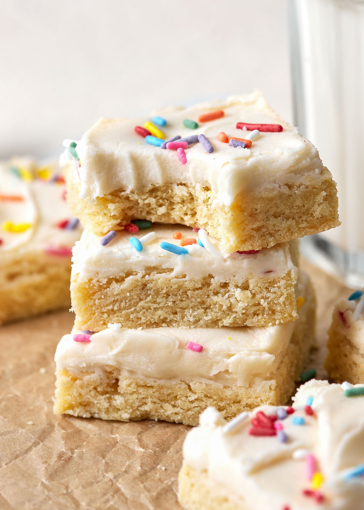 Sugar Cookie Bars wth sprinkles on them in a stack on a worktop. 