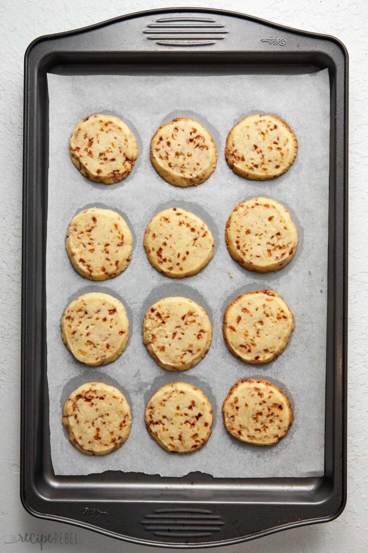 a black pan of baked toffee shortbread on white surface.