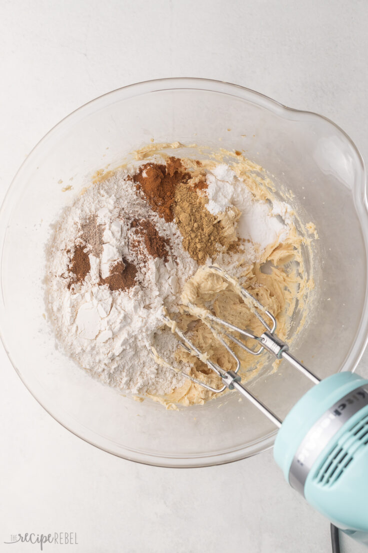 dry ingredients added to mixing bowl with mixer beside.