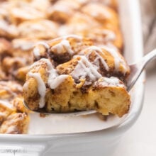 Close up of Cinnamon Roll Casserole with a fork taking out a slice.