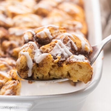 Close up of Cinnamon Roll Casserole with a fork taking out a slice.