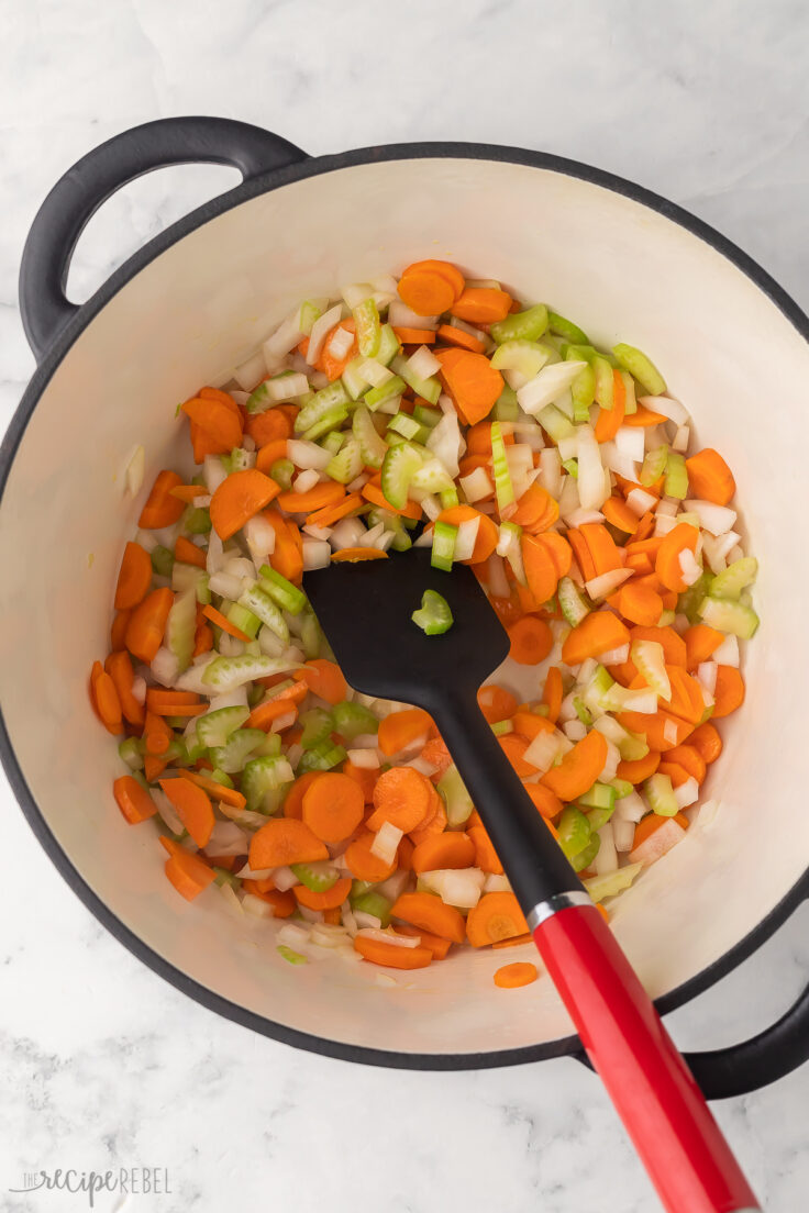 large pot filled with chopped vegetables and spatula.