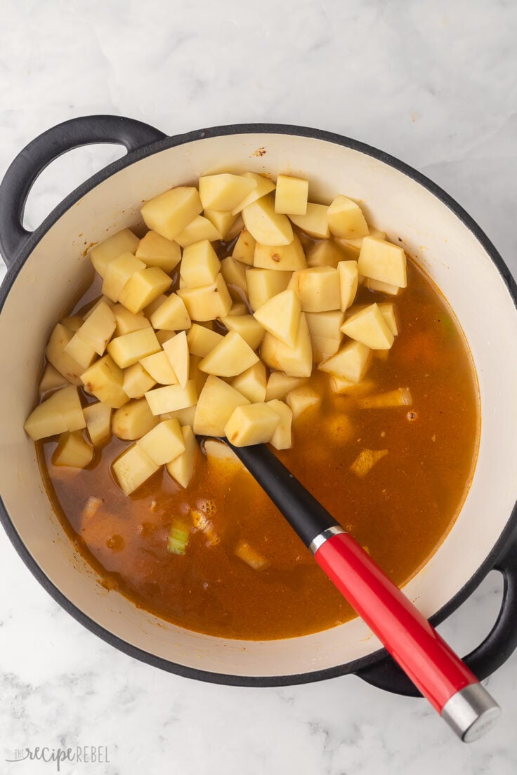 large pot of nacho potato soup with broth and potatoes added.