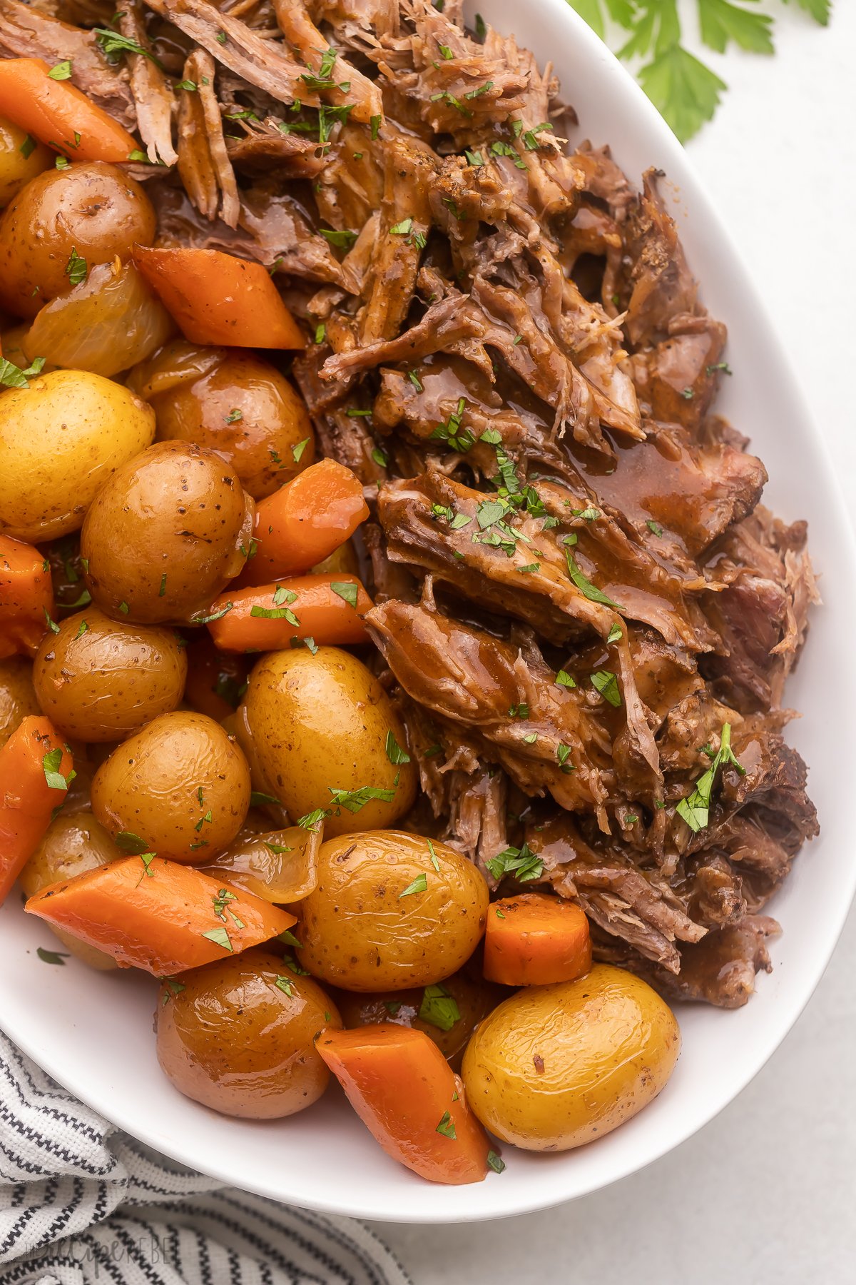 Top view of Pot Roast served in a large white serving dish. 