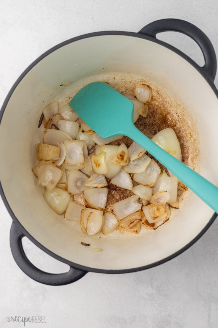 Top view of Dutch oven with onions being sauteed in oil