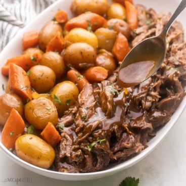 Top view of Pot Roast served in a large white serving dish.