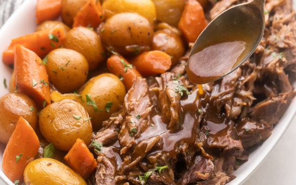 Top view of Pot Roast served in a large white serving dish.