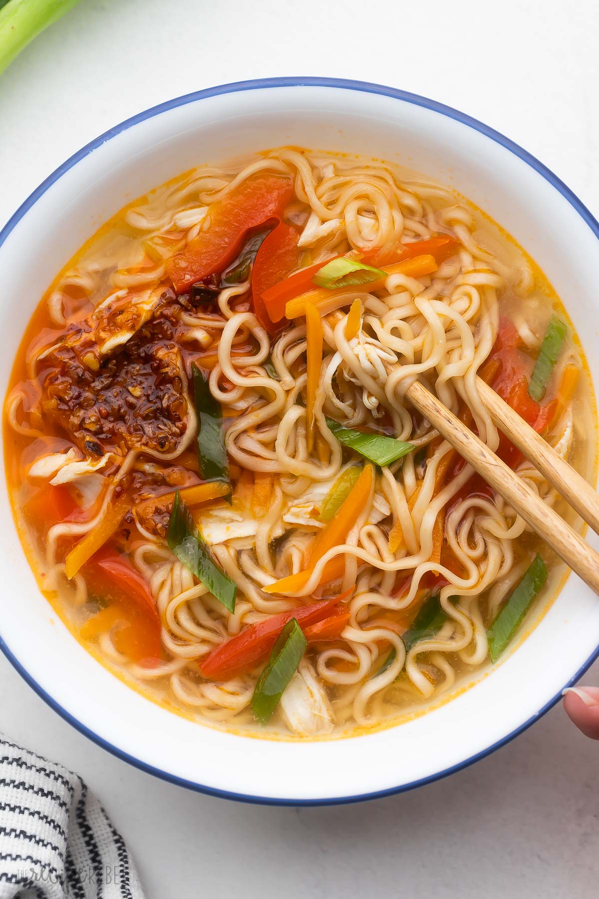 overhead image of ramen noodle soup with chop sticks.
