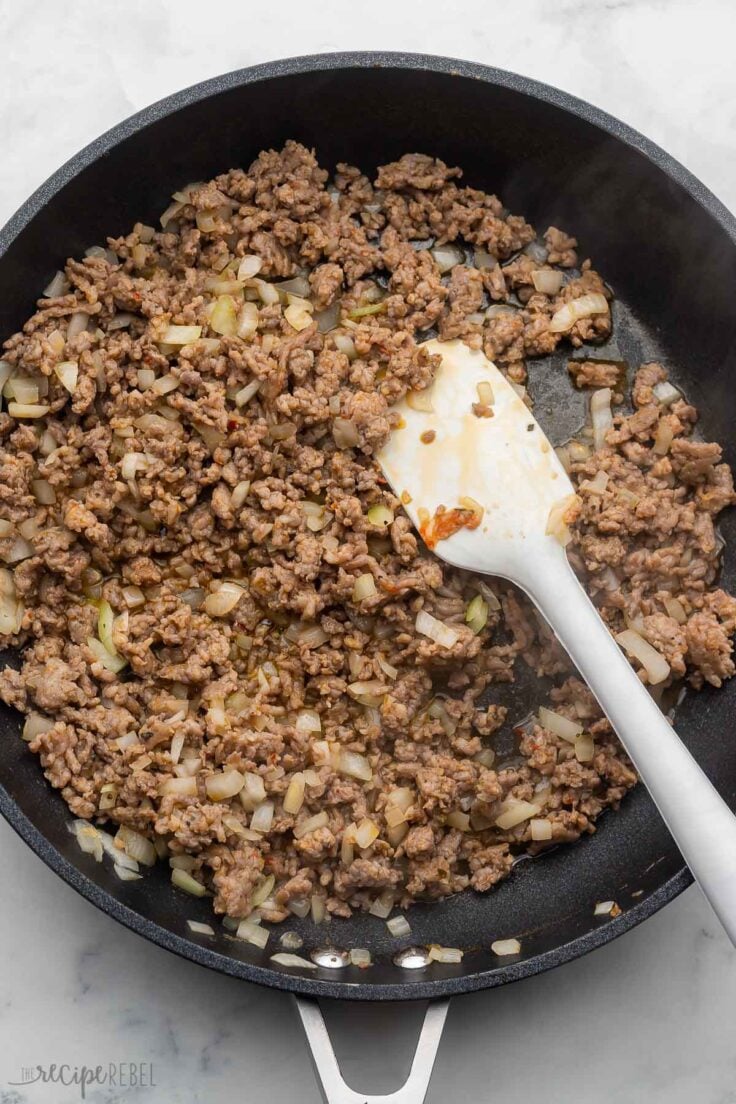 cooked sausage and onion in black skillet.