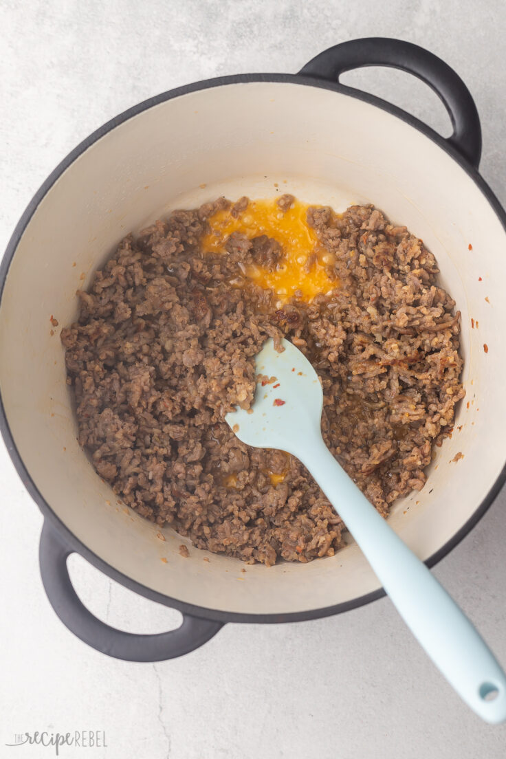 sausage being browned in large dutch oven.