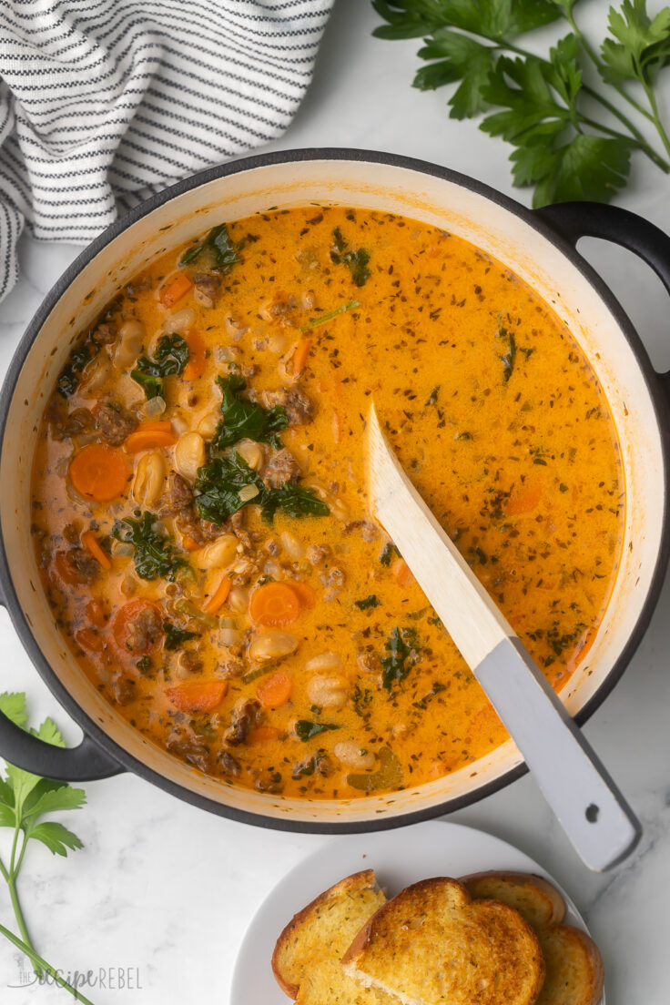 finished white bean soup with a wooden spoon.