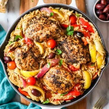 overhead image of greek chicken orzo in skillet.