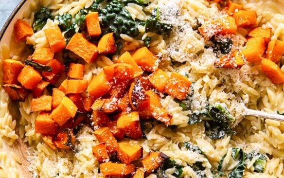 creamy orzo pasta with butternut squash in large skillet.