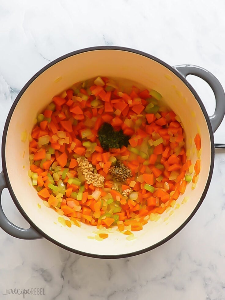 Carrots onion and celery sauteed in pot and spices added.