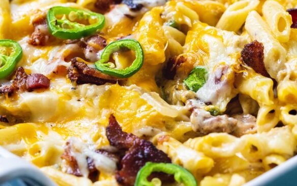 A close up shot shows a jalapeno popper chicken casserole in a baking dish.