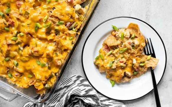 A plate of king ranch chicken casserole is plated next to a whole dish.