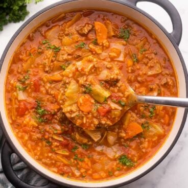 overhead square image of cabbage roll soup in pot.