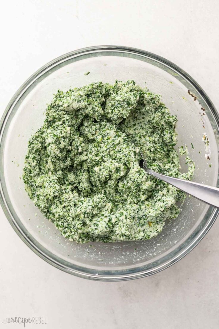 ricotta stuffing ingredients mixed in a glass bowl.