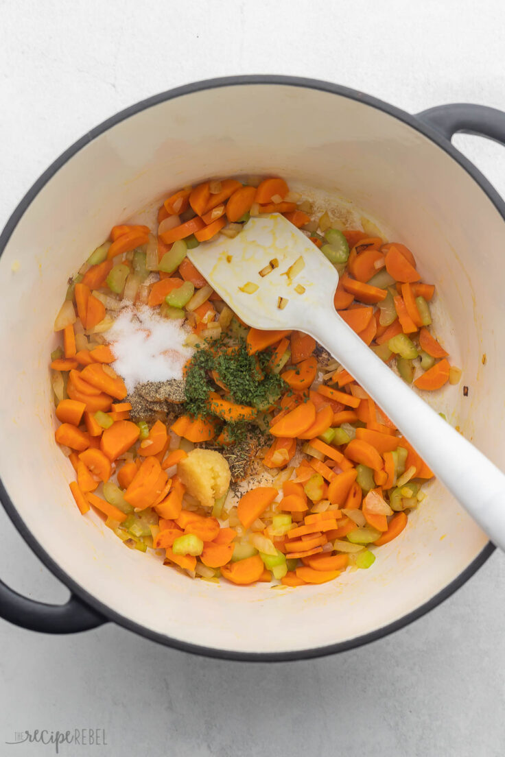 sauteed vegetables in large pot with spices added.