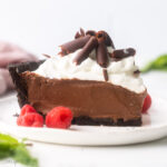 square image of slice of french silk pie on a white plate.
