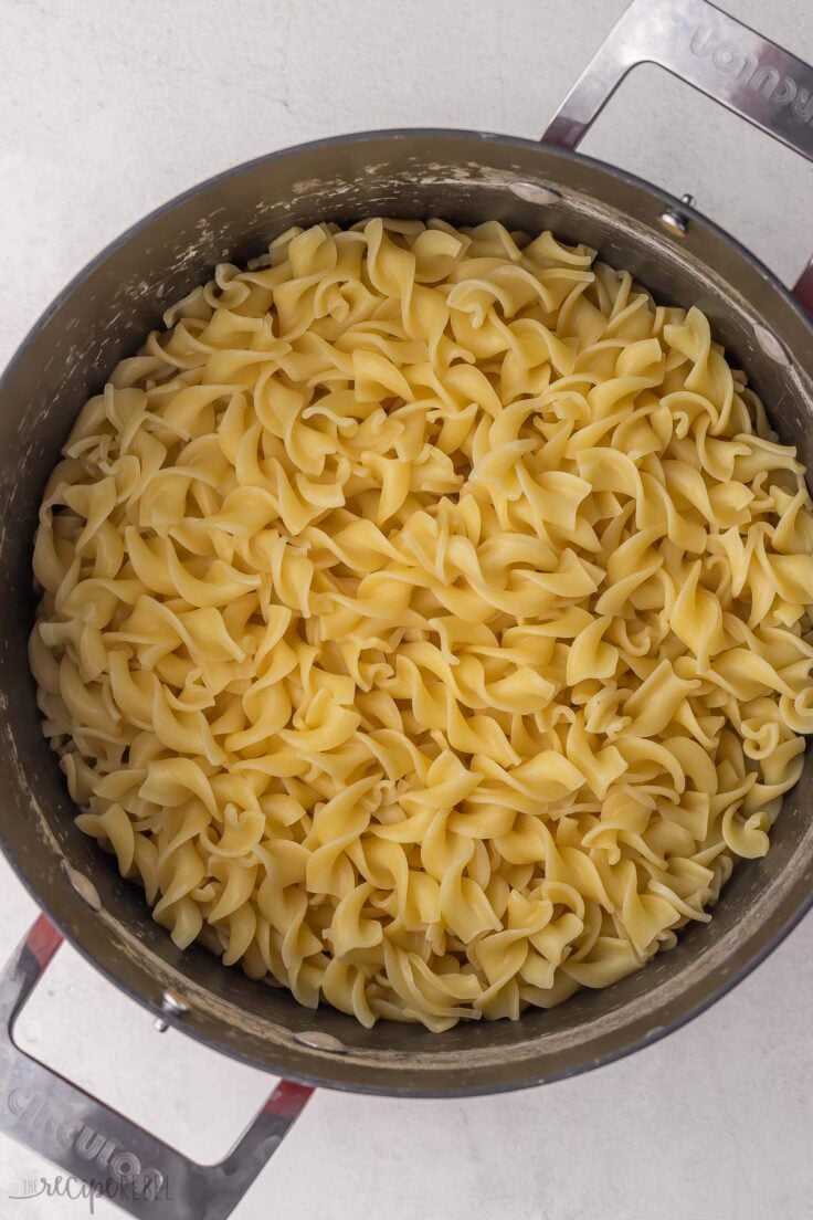 large pot of cooked pasta on grey surface.