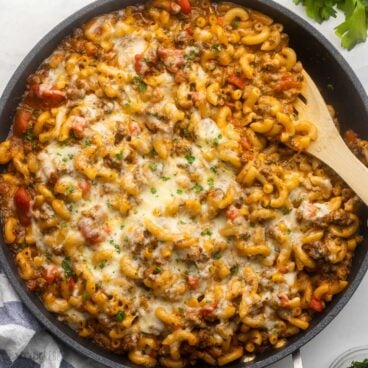 a full pan filled with homemade hamburger helper and topped with chopped parsley.